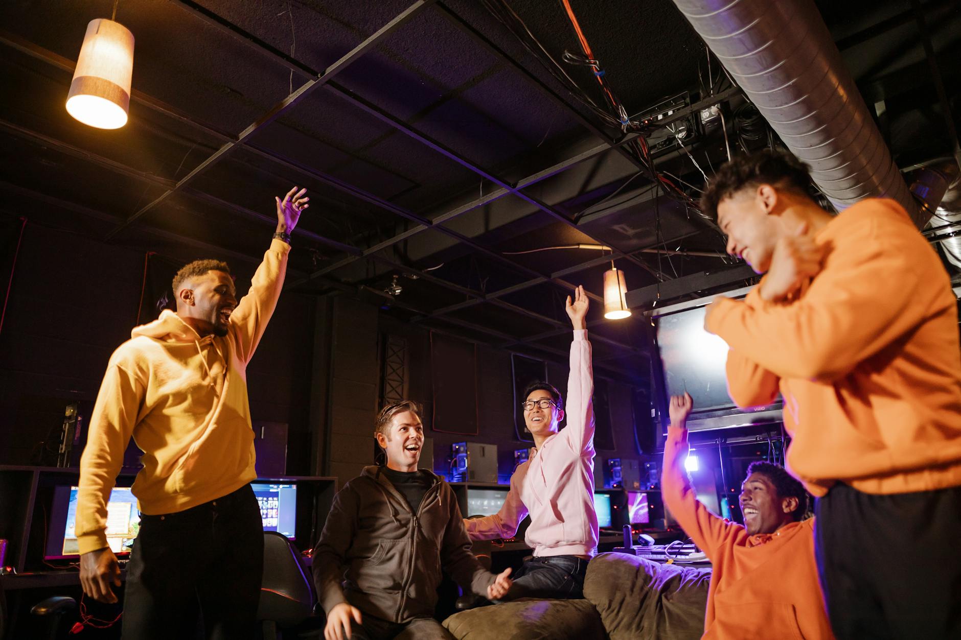 Diverse group of people smiling and doing a light stretch indoors.
